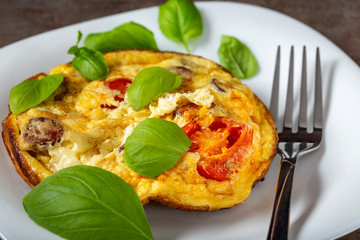 Breakfast food - Omelette with pork sausages, cheese, onion and cherry tomatoes