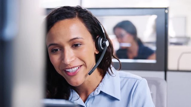 Young mixed race woman working in a call centre