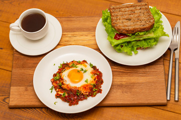 Coffee, sandwich and fried egg. Delicious breakfast