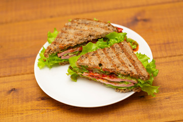 Ham, cheese, tomato and salad sandwich
