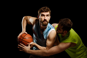 Two men playing basketball