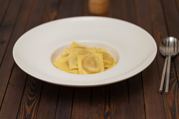 Plate of ravioli on dark background