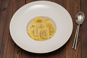 Plate of ravioli on dark background