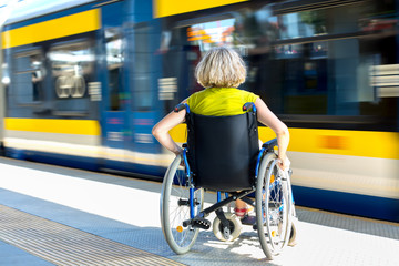 woman sitting on wheelchair on a platform