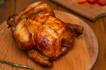 Roasted chicken on cutting board.