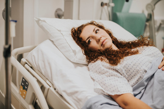 Female patient resting in a hospital bed