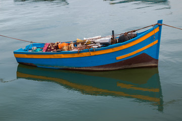 Naklejka na ściany i meble Small wooden boat in the bay, Rabat, Morocco