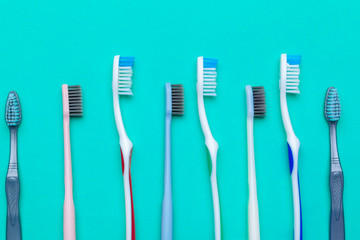 Flat lay composition with manual toothbrushes on color background, close up