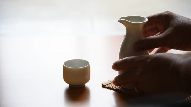 Asian men Pouring japanese sake oriental drink style