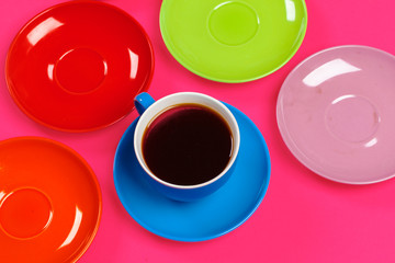 Colorful coffee cups and saucers on colorful vibrant background