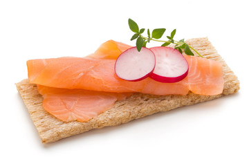 Bread with fresh salmon fillet isolated on white background, top view.