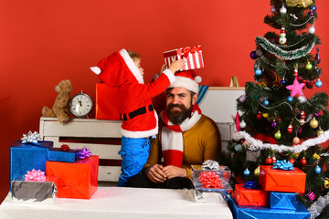 Christmas family opens presents on red background