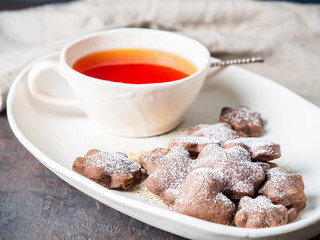 Winter holiday composition, side view, copy space, gray blue background. Tea, flax cookies with cinnamon
