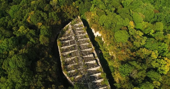 Aerial view of beautiful ancient fortress in forest in summer. Tarakaniv Fort.
