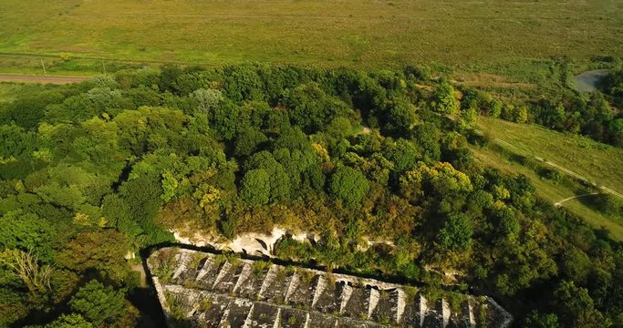 Aerial view of beautiful ancient fortress in forest in summer. Tarakaniv Fort.