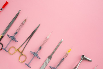 Flat lay of medical instruments on rose background. Mock up health care medical background.