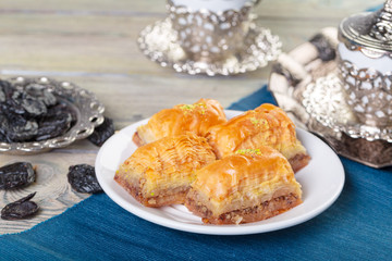 Oriental sweets, baklava, sherbet on a blue background