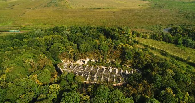 Aerial view of beautiful ancient fortress in forest in summer. Tarakaniv Fort.