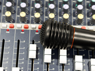 Black microphone on audio mixer in studio top view