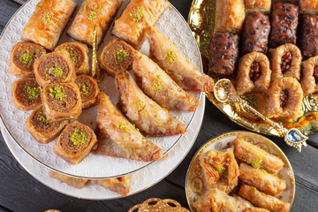 baklava with pistachio. turkish traditional delight on a dark wood background