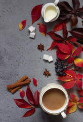 Cup of coffee, spices, sugar cubes, autumn leaves. Autumn decor, fall mood, relaxing and still life concept. Flat lay, top view. Copy space.