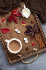 Cup of coffee, spices, sugar cubes, autumn leaves. Autumn decor, fall mood, relaxing and still life concept. Flat lay, top view. Copy space.