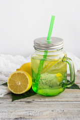 Water with lemon in a glass jar.