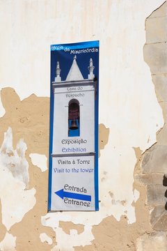 Visit the tower sign on the front of the Misericordia church (Igreja da Misericordia), Tavira, Algarve, Portugal.