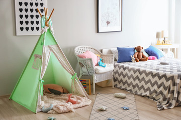 Cozy play tent for kids in interior of room