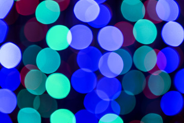 Blurred view of beautiful lights on dark background