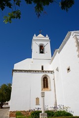 Fototapeta na wymiar View of the Santa Maria do Castelo church (Igreja de Santa Maria do Castelo) bell tower, Tavira, Algarve, Portugal.