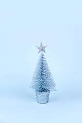 Christmas wooden tree over light blue background.