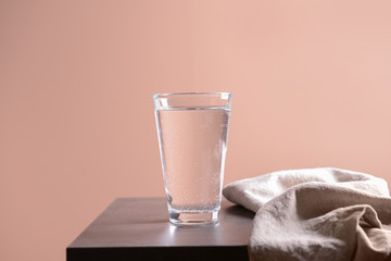 Glass of cold water on table