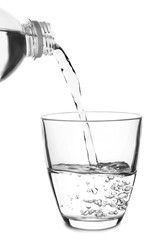 Pouring of water in glass on white background