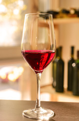 Glass of red wine on wooden table