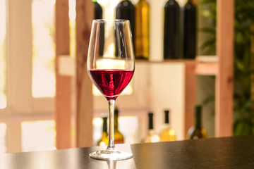 Glass of red wine on dark table