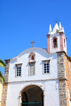 View of St Marys Church (Igreja de Santa Maria) along Praca Doctor Antonio Padinha, Tavira, Algarve, Portugal.