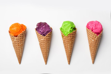 Waffle cones with delicious color ice cream on white background