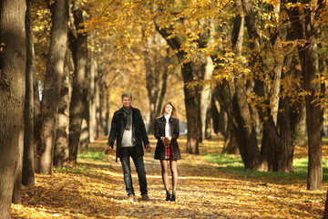Obraz premium couple people young man and women walking autumn park fanny sunny day