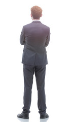 rear view, full-length of a businessman standing and looking forward.