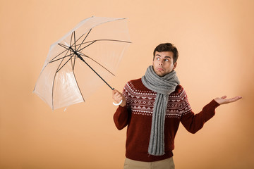 Portrait a confused young man dressed in sweater