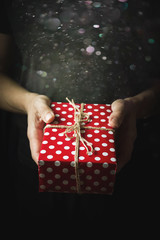 Hands holding a small gift