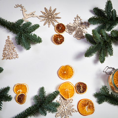 The Branches of a Christmas tree with dry oranges and New Year's toys. Christmas card