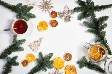 Fototapeta na wymiar The Branches of a Christmas tree with dry oranges and New Year's toys. Christmas card