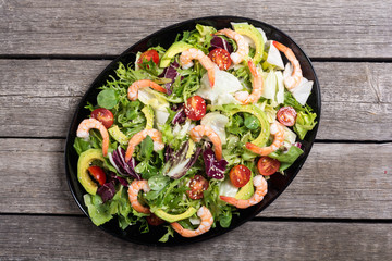 Mix of salad with shrimps , avocado and cherry tomatoes