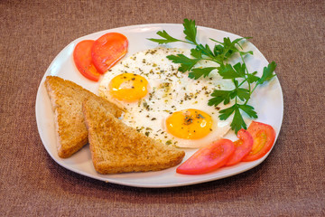 Fototapeta na wymiar breakfast on plate, fried eggs with vegetables