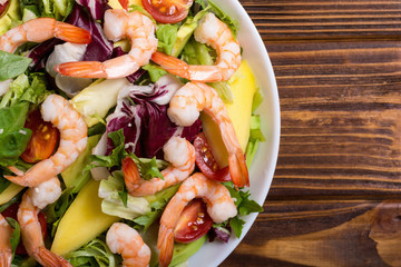 Mix of salad with shrimps , avocado and cherry tomatoes