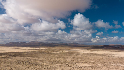 Fototapeta na wymiar aerial view of desert and volcanic mountains