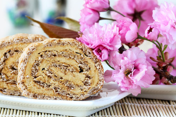 Japonais cake with cherry flower as decoration (a Japonaise cake is charecterised by layers of creamy coffee buttercream sandwiched between almond meringue discs).