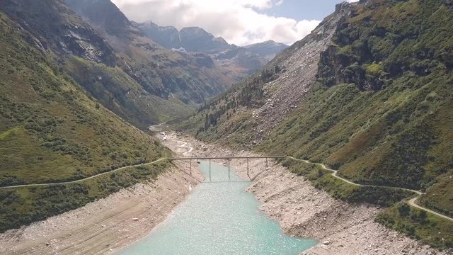 Drone flight over a reservoir with a metal bridge